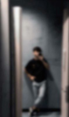 a blurry photo of a man standing in an elevator