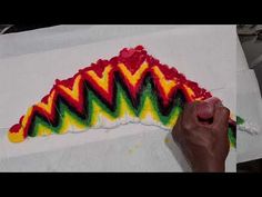 someone is working on an art project with colored paper