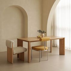 a dining table with two chairs next to it and a potted plant on top