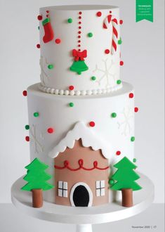 a three tiered cake decorated with christmas decorations