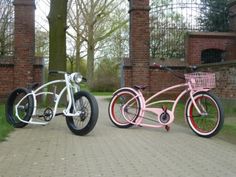 two bikes parked next to each other on a brick road