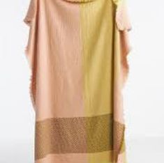 a woman is wearing a pink and yellow blanket