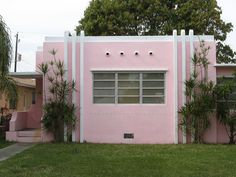 a pink house with white trim and windows