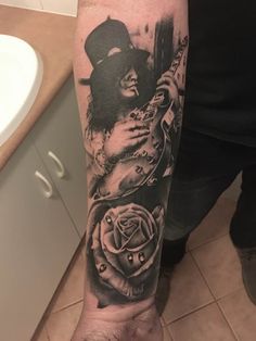 a person with a tattoo on their arm holding a guitar and roses in front of them