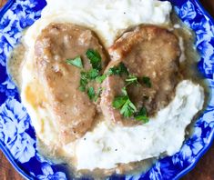 two heart shaped meatballs with gravy on top of mashed potatoes