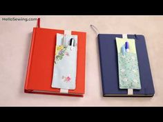 two notebooks with pens on them sitting next to each other