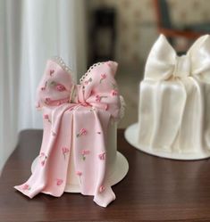 two cakes decorated with bows on top of a table