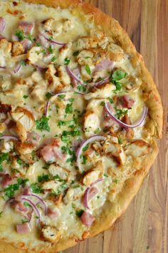 a pizza sitting on top of a wooden cutting board covered in cheese and toppings