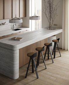 a kitchen island with three stools next to it