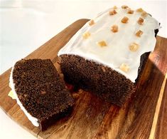 a loaf of cake with white frosting and nuts on top