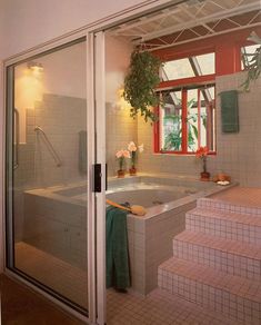 an indoor jacuzzi tub in the middle of a room with tiled floors and walls