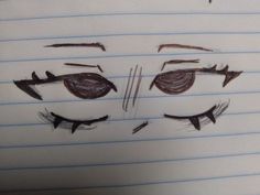 a drawing of a face with eyes drawn on lined paper