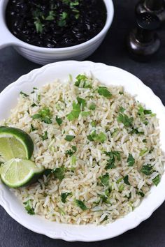 rice with cilantro, lime and black beans in a white bowl on a table