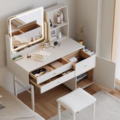 a white desk with drawers and a mirror on it's side next to a bed