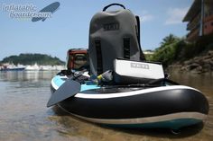 an inflatable boat is sitting on the water with a life jacket attached to it