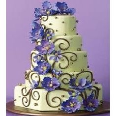 a three tiered cake with blue flowers on it