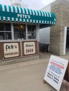 a sign is in front of a store that sells pet's and hamburgets