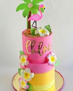 a pink and yellow cake with a flamingo on top