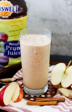 an apple smoothie with cinnamon and apples next to it