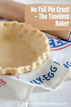 an uncooked pie crust sitting on top of a table next to measuring tape