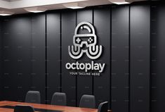 a conference room with black chairs and a wooden table in front of a wall that reads octopus play