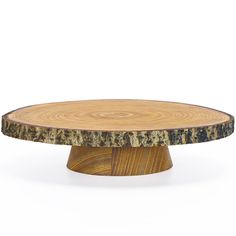 a round wooden table with black and brown wood grain on the top, against a white background