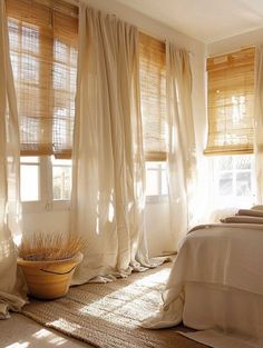 the sun shines through the sheer curtains in this bedroom with white bedding and pillows