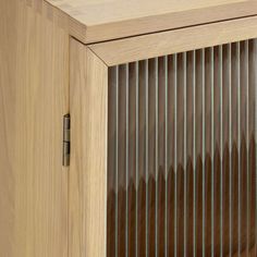 a wooden cabinet with metal slats on the doors