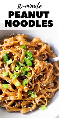 a white bowl filled with noodles and topped with sesame seeds