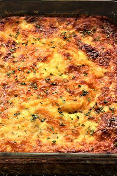 a casserole dish with cheese and herbs