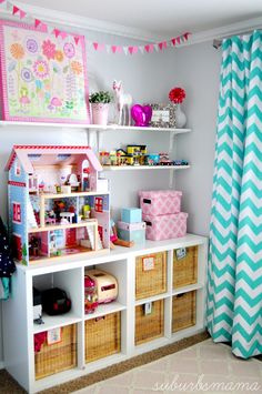 a child's playroom with toys and bookshelves on the shelves in front of it