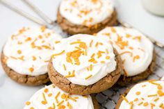 several cookies with white frosting and sprinkles