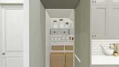 an open pantry with white cabinets and baskets