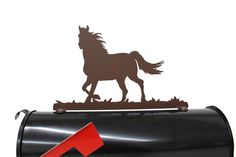 a mailbox with a horse on it and a red arrow pointing to the right