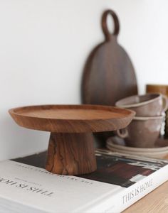 a wooden plate sitting on top of a book