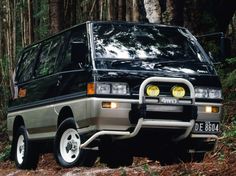 an suv is parked in the woods by itself