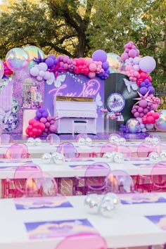 an outdoor party setup with balloons and decorations