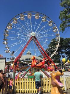 a carnival ride with people standing around it