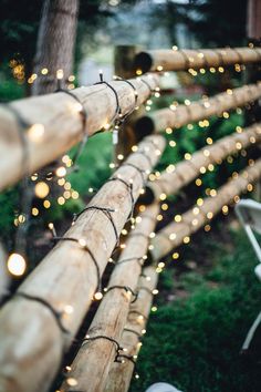 lights are strung up on the side of a wooden fence