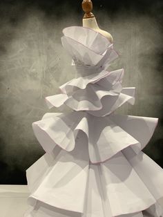 a dress made out of paper with a mannequin on top