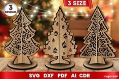 three wooden christmas trees with ornaments on the top and bottom, sitting on a table in front of a christmas tree