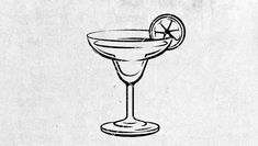 a black and white drawing of a martini glass with a slice of lemon on the rim