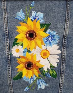 a jean jacket with flowers painted on it