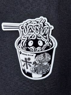 a sticker depicting noodles in a cup with chopsticks sticking out of it