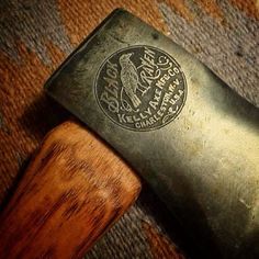 an old metal and wood shaving knife on carpeted area with wooden handle next to it