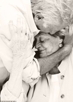 an old man and woman hugging each other in front of a quote from the poem