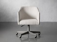 a white office chair with wheels on a gray floor