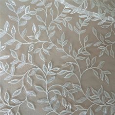 the wall paper has white flowers and leaves on it, as well as brown background