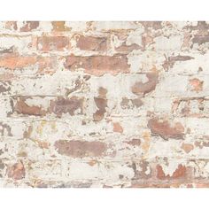 an old brick wall with white and brown paint