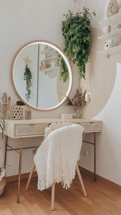 a room with a desk, mirror and potted plants on the wall next to it